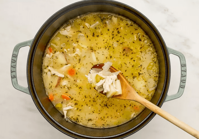Flour stirred into sautéed vegetables to form a thick roux for creamy chicken pot pie soup