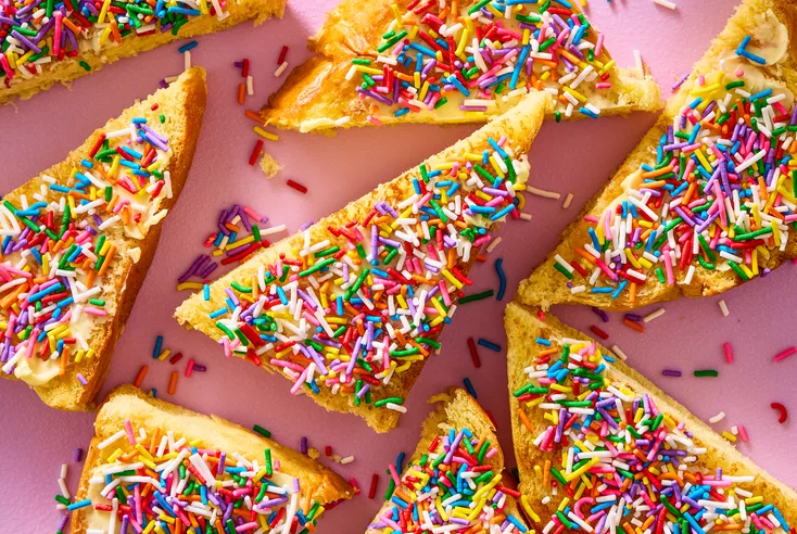Tray of Dutch sprinkle toast served with fresh berries and yogurt showing a fun and flexible three ingredient Dutch breakfast spread