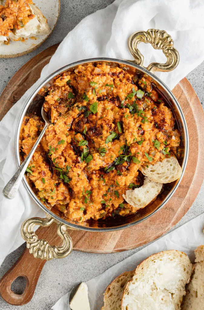 Skillet of menemen Turkish scrambled eggs and tomatoes served with bread