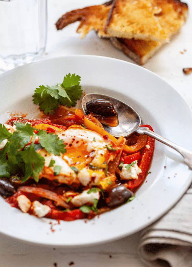 Shakshuka in a plate served with bread