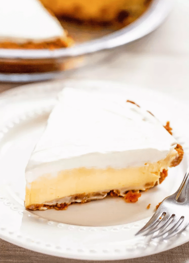 Lemons, sweetened condensed milk, eggs, and graham crackers arranged for making lemon icebox pie