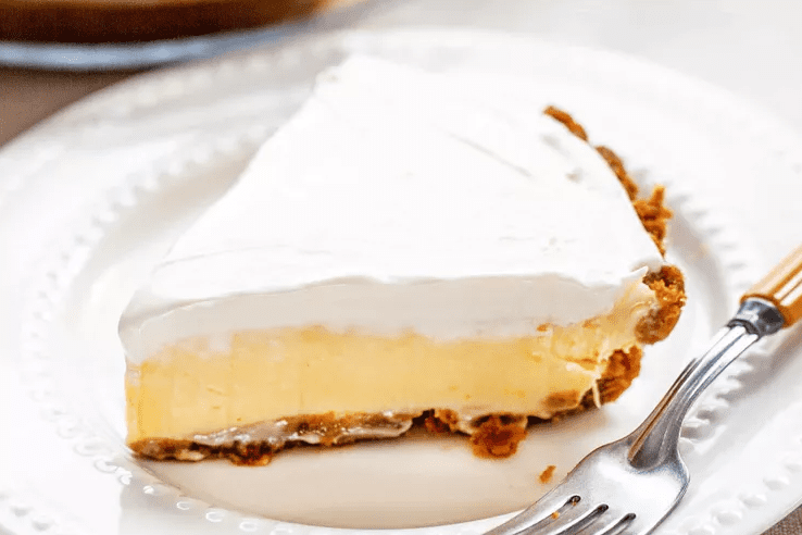 Cutting a chilled lemon icebox pie into clean slices with a knife wiped between cuts