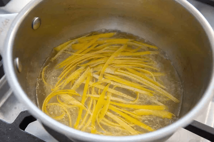 Zesting a lemon into sugar for lemon tart filling, avoiding the white pith