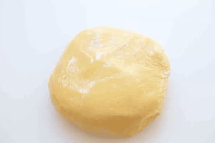 Wrapped tart dough disk chilling in the refrigerator before rolling