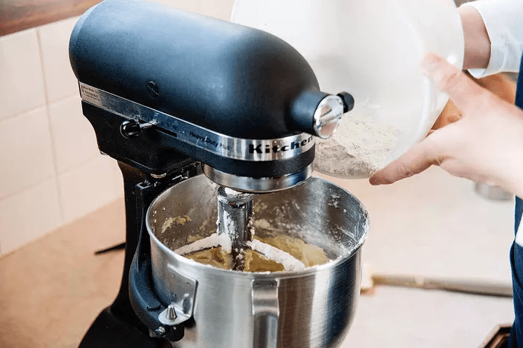 Adding flour over the batter mix