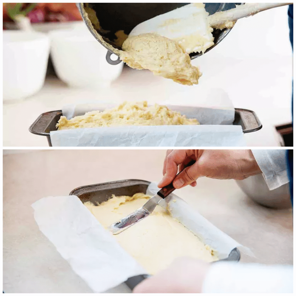 Thick lemon pound cake batter smoothed evenly in a parchment lined loaf pan before baking