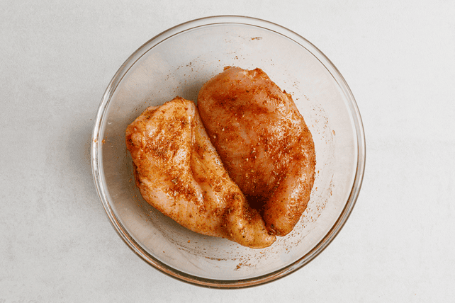 Chicken breasts coated with seasoning before air frying